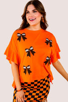 fluttery ruffle short-sleeve top with a mom crop length, sewn-on chenille football bow patches outlined in sequins on a soft, stretch-knit fabric in orange