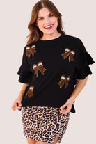 fluttery ruffle short-sleeve top with a mom crop length, sewn-on chenille football bow patches outlined in sequins on a soft, stretch-knit fabric in black