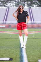 a playful V-neckline top with a ric rac trim detailing on the layered ruffled short sleeves