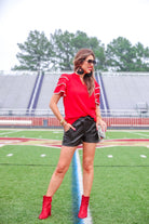 a playful V-neckline top with a ric rac trim detailing on the layered ruffled short sleeves