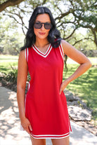 a red two-piece sleeveless tunic and biker short set with varsity stripe trim, V-neckline, side slits, side pockets, soft stretch fabric, and pre-washed finish