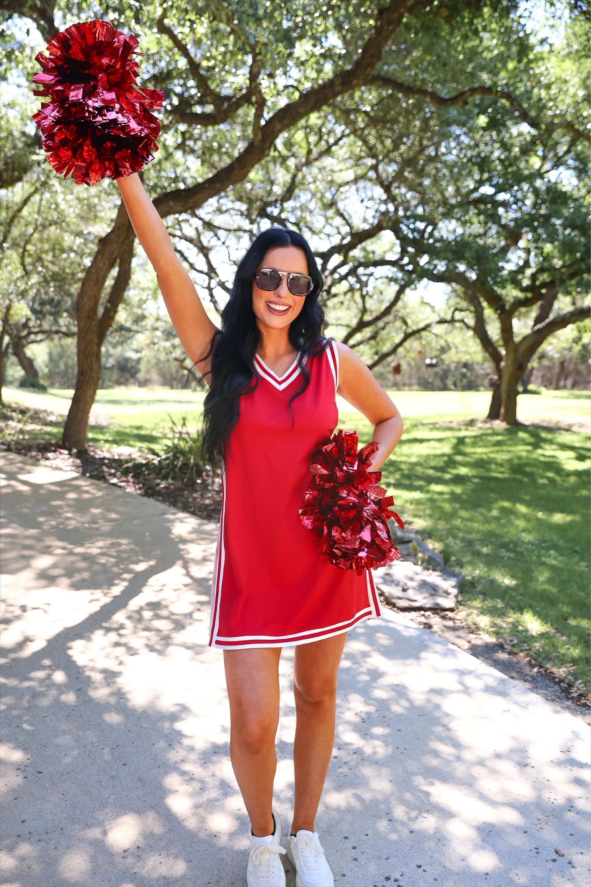 a red two-piece sleeveless tunic and biker short set with varsity stripe trim, V-neckline, side slits, side pockets, soft stretch fabric, and pre-washed finish