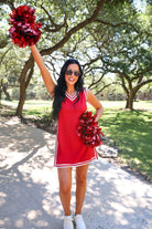 a red two-piece sleeveless tunic and biker short set with varsity stripe trim, V-neckline, side slits, side pockets, soft stretch fabric, and pre-washed finish