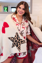ultra-soft reversible throw on a leopard star and red bow pattern print fabric