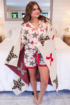 ultra-soft reversible throw on a leopard star and red bow pattern print fabric