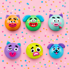 round changeable face squishy balls with a soft matte-like surface, squeezable construction, assorted removable facial pieces, customizable expressions, vibrant color options, and individual packaging in blue, green, mint, orange, purple, and yellow