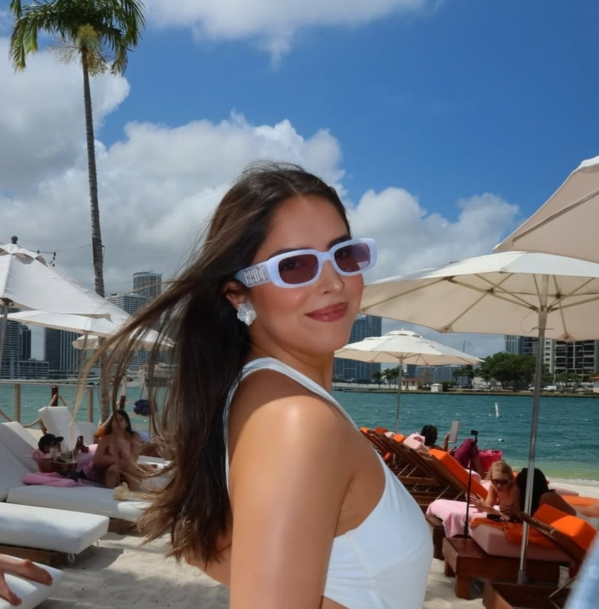 Woman on a beach with palm trees and ocean view