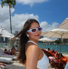 Woman on a beach with palm trees and ocean view