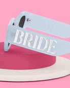 Sunglasses with 'BRIDE' text on a pink and white background