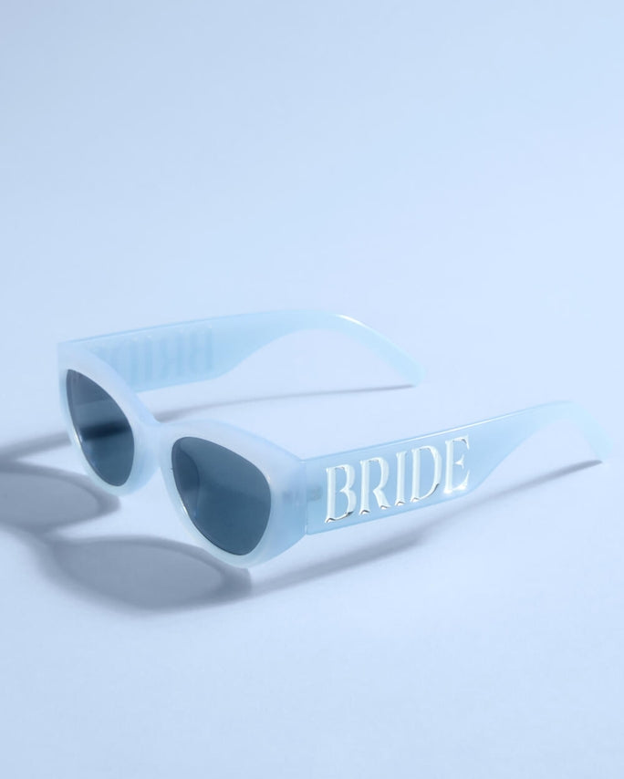 Light blue sunglasses with 'BRIDE' text on a light blue background