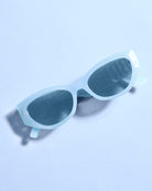 Light blue sunglasses on a light blue background