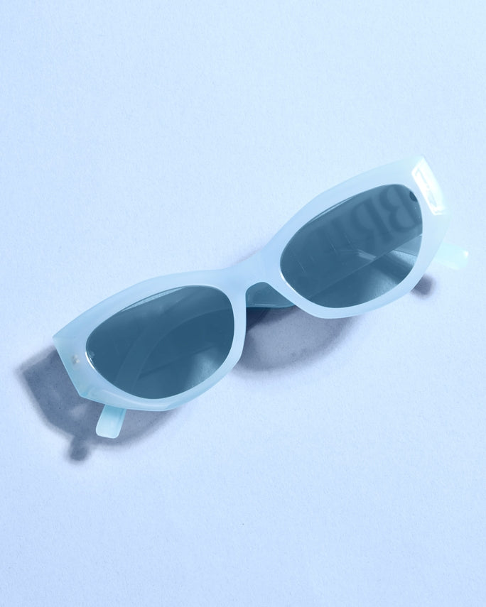 Light blue sunglasses on a light blue background