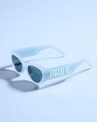 Sunglasses with 'BRIDE' text on a light blue background