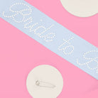 Bridal sash with 'Bride to be' text on a pink and blue background