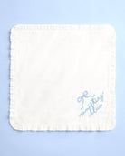 White square pillow with blue text on a light blue background