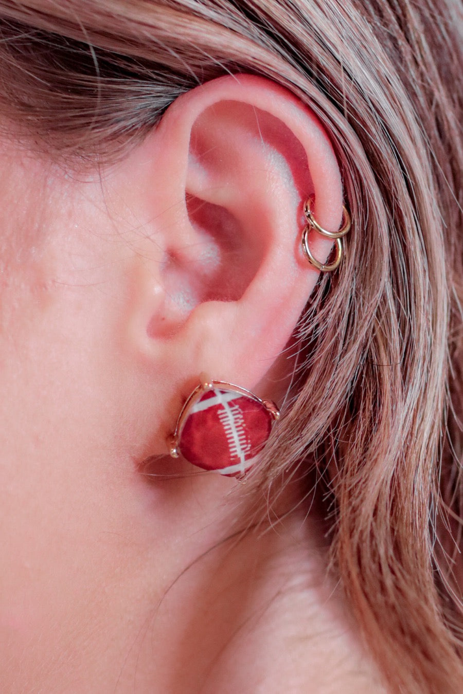 lightweight stud earrings with sporty prints with gold post-style earring backs and clear rubber stopper in brown for football