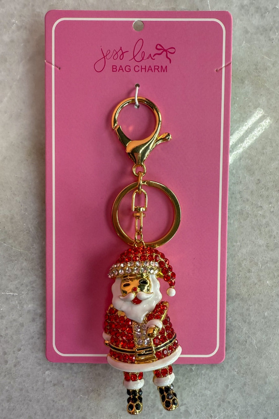 a gleaming Santa bag charm with sparkling rhinestones, movable arms, a solid heavyweight feel, a gold-tone swivel clasp with matching keyring, and a fully gold openwork back for added dimension