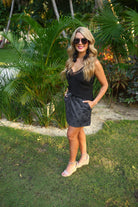 mid-rise relaxed fit everyday skort made of lightweight material with built-in black shorts, drawstring tie, an elastic band on the back, and side pockets, designed on a two-tone black star pattern print
