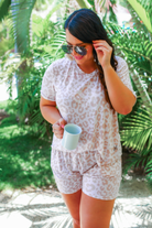 a neutral taupe animal print lounge set crafted from soft stretch fabric with a short-sleeve V-neck top, matching pull-on shorts, elastic waistband, side pockets, and relaxed fit