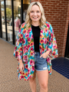 an exclusive, vibrant multicolor floral open-front kimono crafted from limited boutique fabric with lightweight woven material and a fluid, elongated drape