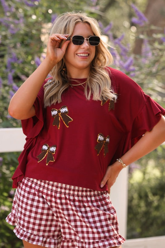 high-waisted gingham shorts with smocked waistband and ruffle hem in maroon