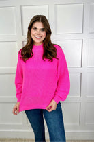 pink long sleeve sweater with a drop-shoulder for a relaxed fit, a crew neckline, and a ribbed hemline on a textured ultra-soft design fabric