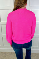 pink long sleeve sweater with a drop-shoulder for a relaxed fit, a crew neckline, and a ribbed hemline on a textured ultra-soft design fabric