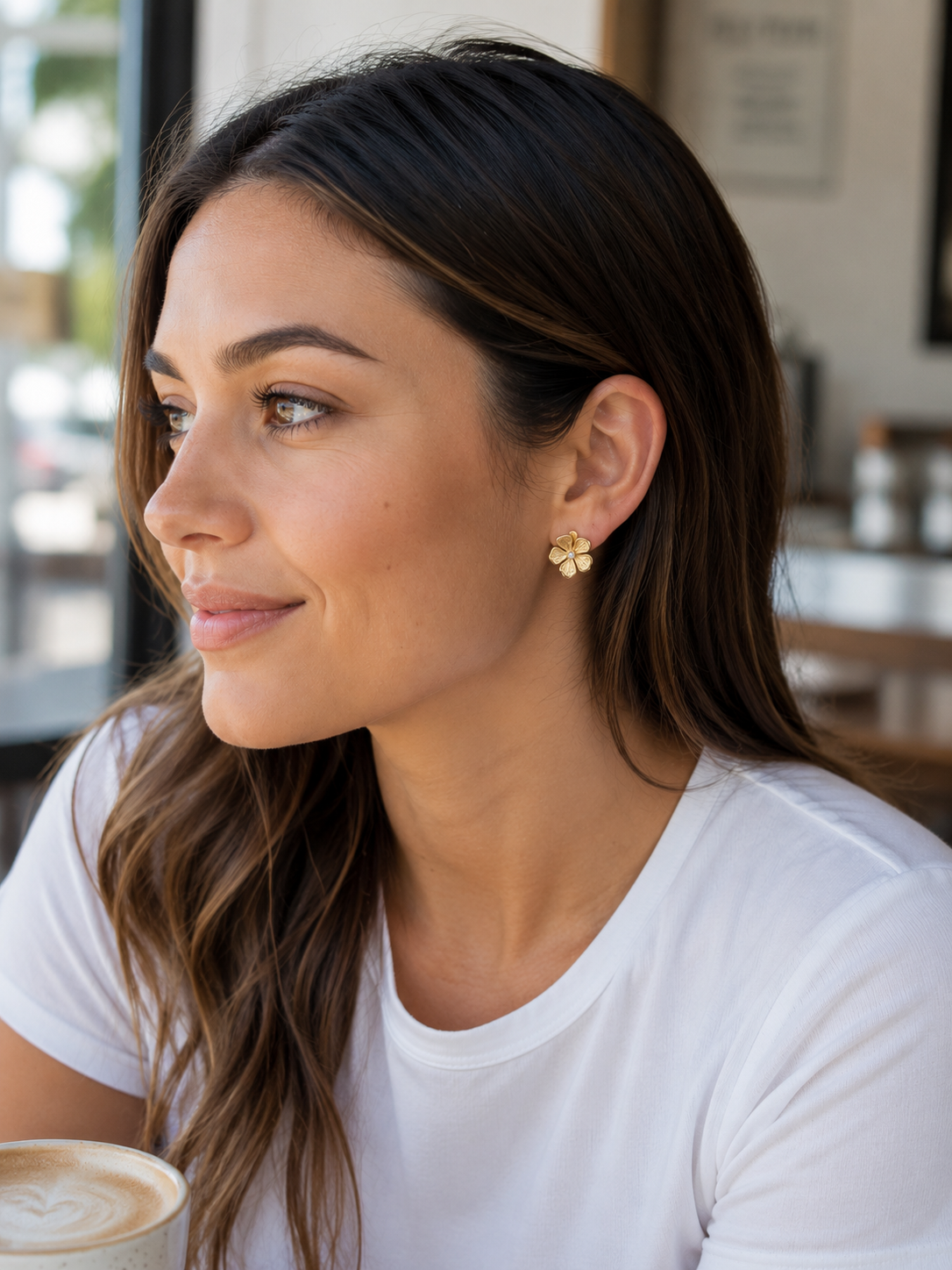 gold intricately detailed flower stud-post earrings with a center stone and gold comfort earring back