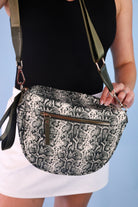 spacious bum bag with double front zippers, a back zipper, an interior zipper pocket, an adjustable strap, and gold hardware accents in slyvie snake