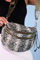 spacious bum bag with double front zippers, a back zipper, an interior zipper pocket, an adjustable strap, and gold hardware accents in slyvie snake