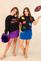 black long sleeve sweatshirt made from a midweight, soft material fabric with a crew neckline, straight hemline, and multicolored letter patches spelling out TEAM HALFTIME&nbsp;on the front