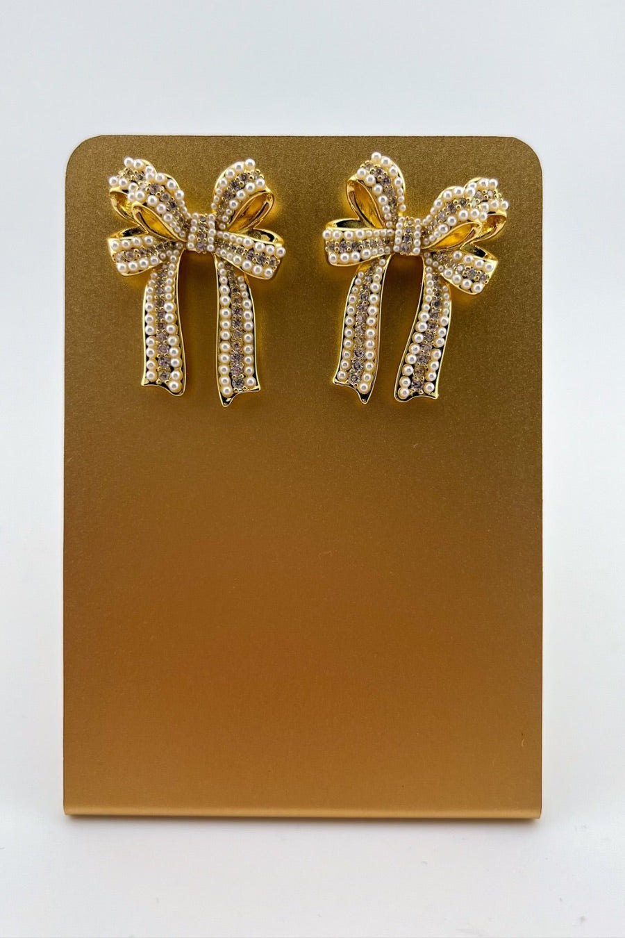 high-quality gold bow post stud earrings with rhinestones and pearl accents and a comfort earring back in gold