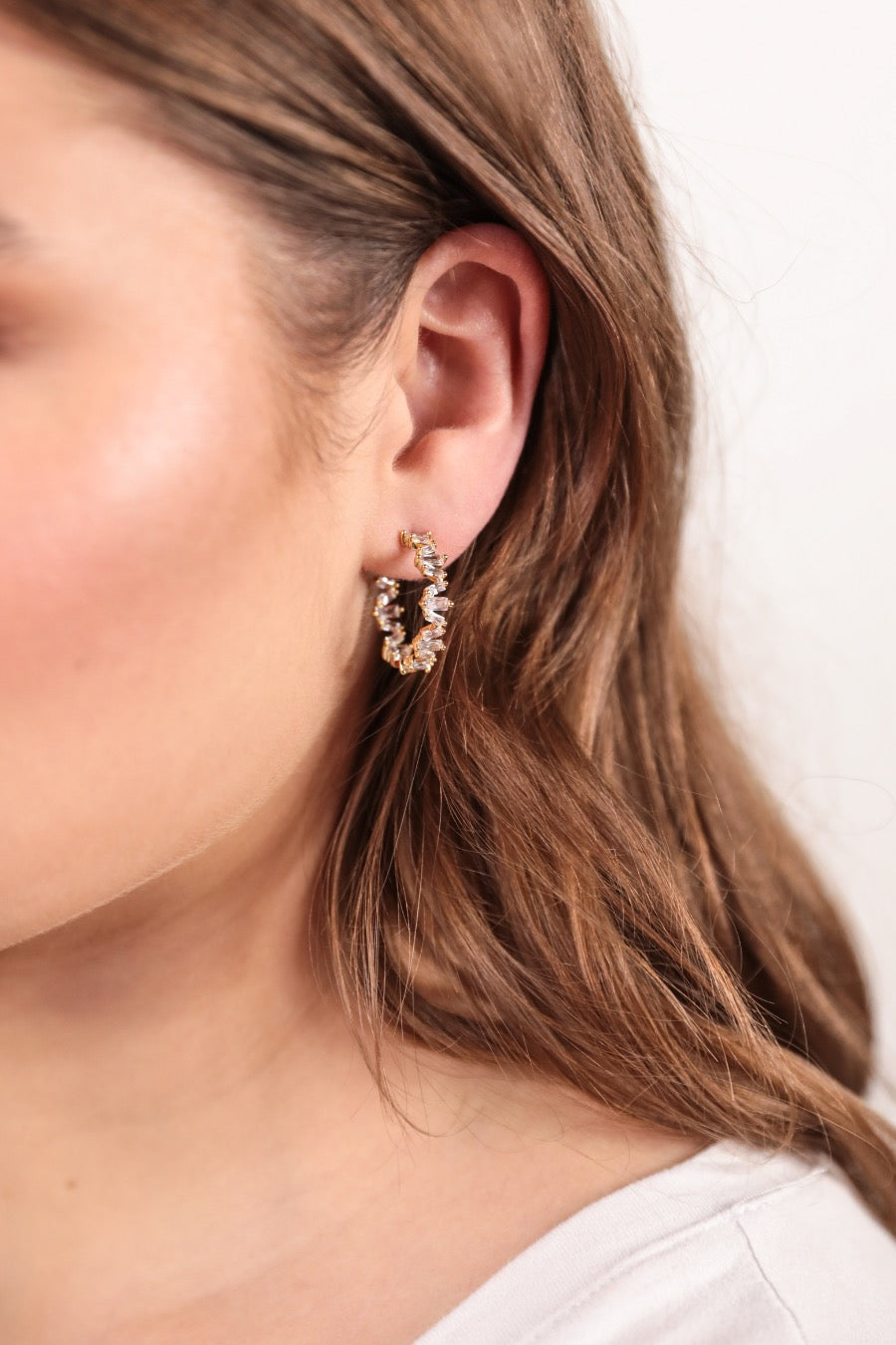 gold-plated rhinestone hoop stud earring with a comfort back earring and plastic disc stopper in gold