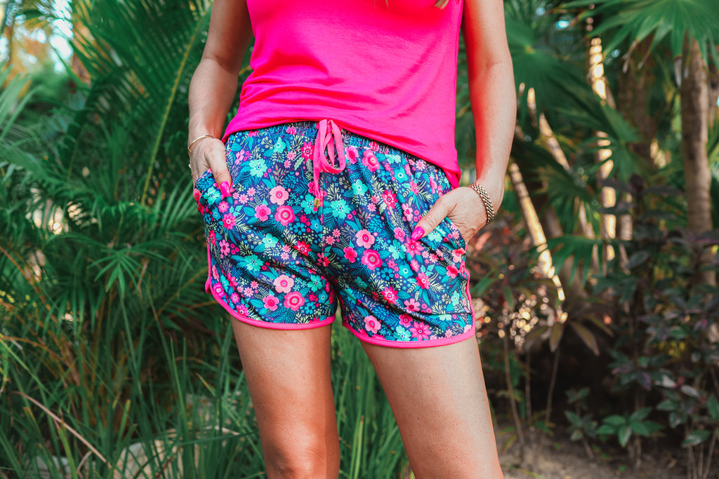 mid-rise, tie waist drawstring, side pockets, & a relaxed fit with a colorful floral pattern