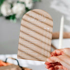 Clear acrylic card with 'He Said She Said' game questions held by a person.