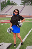 a slimming true to size solid royal blue skort with built-in shorts, interior side pockets, and a pleated back