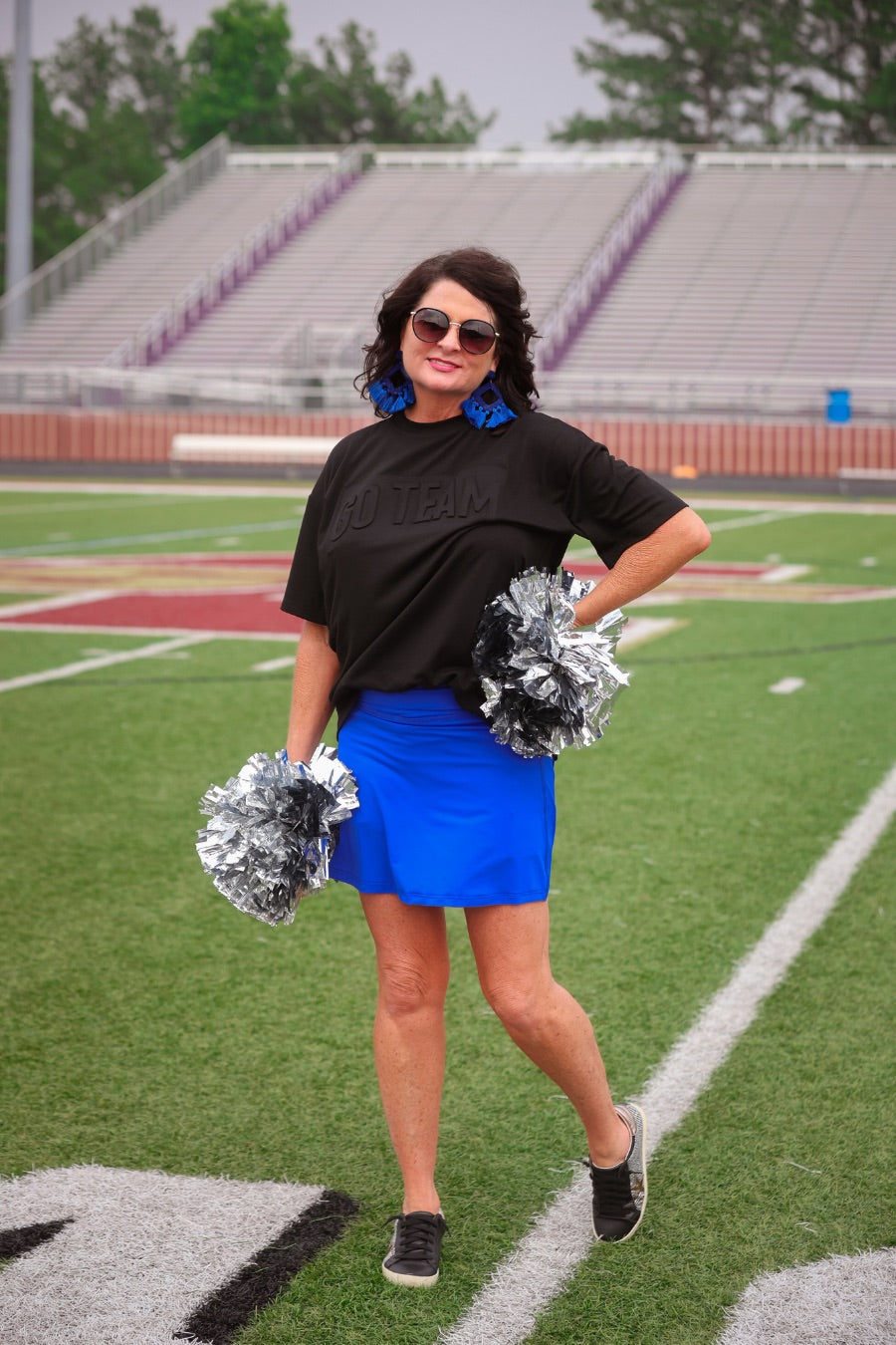 a slimming true to size solid royal blue skort with built-in shorts, interior side pockets, and a pleated back