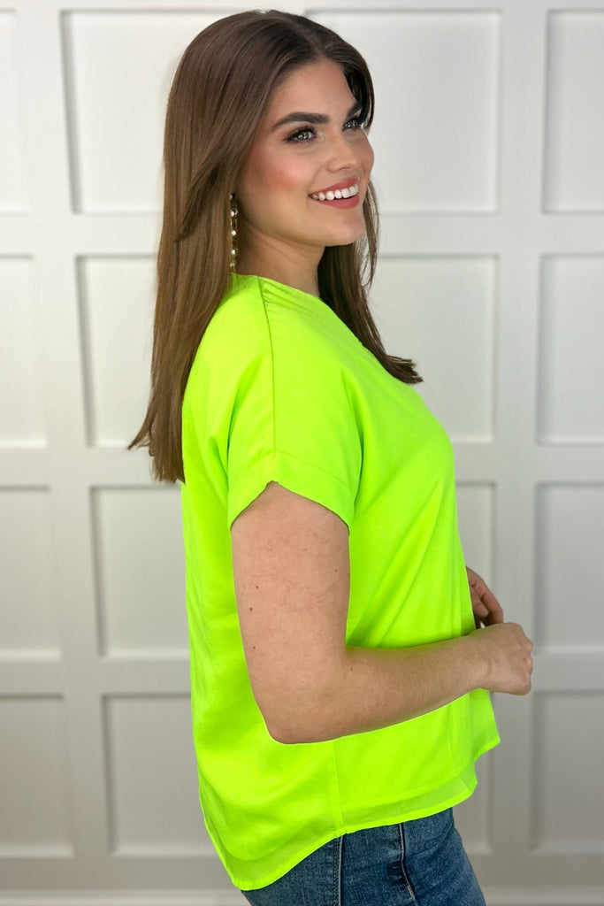 lightweight, soft woven fabric in vibrant neon colors that drapes luxuriously over the body with a modern v-neckline & cuffed short sleeves