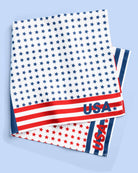 a soft lightweight square polyester bandana with a red, white, and blue flag-inspired print, stars, strips, Team USA lettering, and versatile styling options