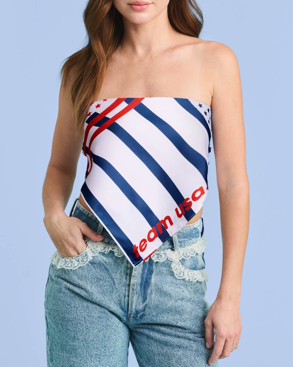 a soft lightweight square polyester bandana with a red, white, and blue flag-inspired print, stars, strips, Team USA lettering, and versatile styling options
