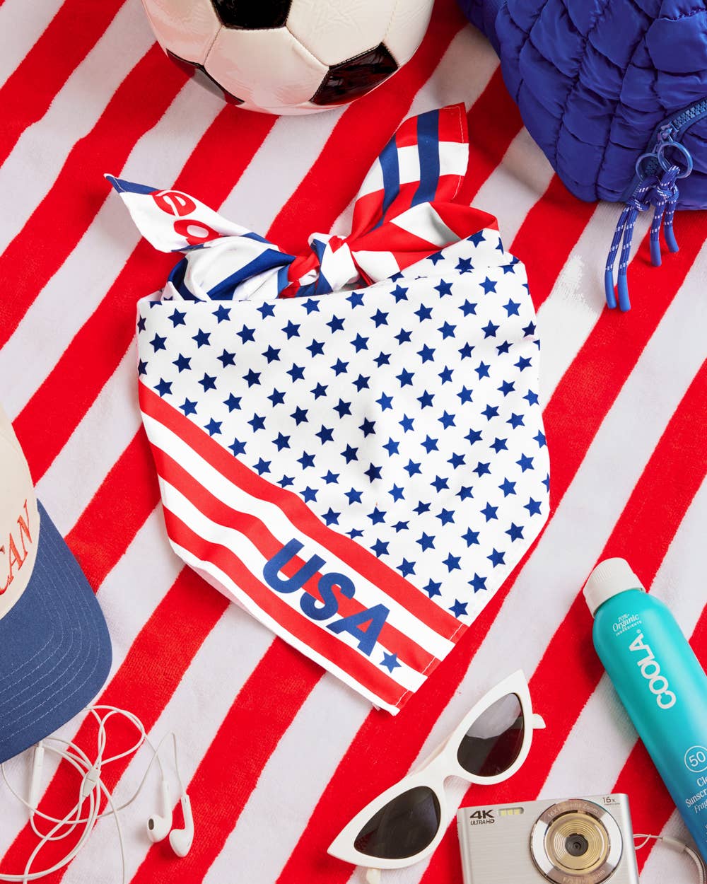 a soft lightweight square polyester bandana with a red, white, and blue flag-inspired print, stars, strips, Team USA lettering, and versatile styling options