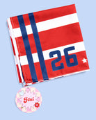 a soft lightweight square polyester bandana with a red, white, and blue flag-inspired print, stars, strips, Team USA lettering, and versatile styling options