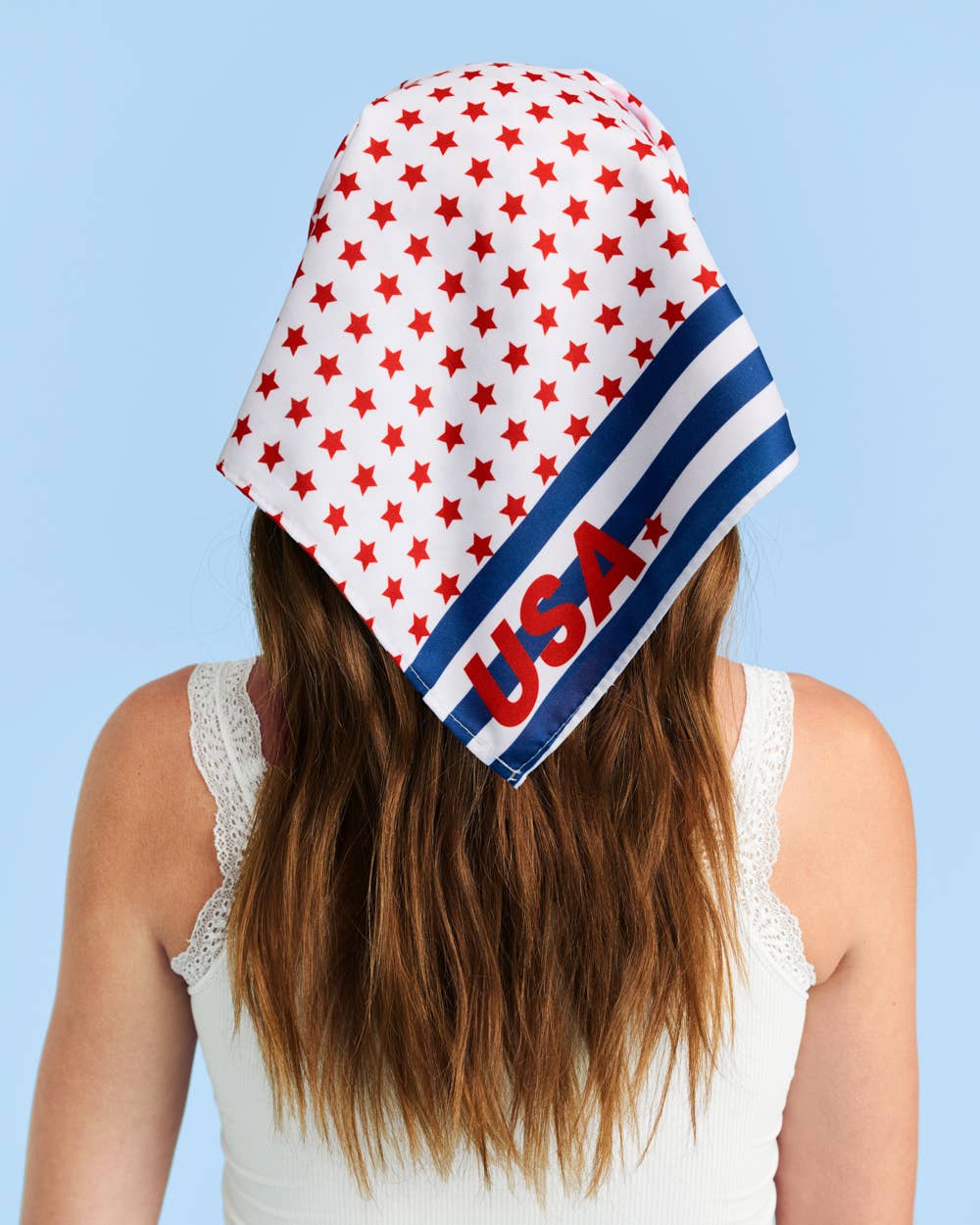 a soft lightweight square polyester bandana with a red, white, and blue flag-inspired print, stars, strips, Team USA lettering, and versatile styling options