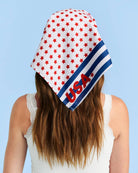 a soft lightweight square polyester bandana with a red, white, and blue flag-inspired print, stars, strips, Team USA lettering, and versatile styling options
