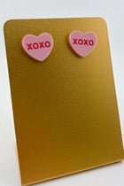 pink heart stud earrings with sweet message XOXO written in the center