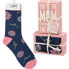 Navy blue socks with pink floral patterns in packaging with a pink box.