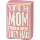 Pink wooden box with white text on a white background