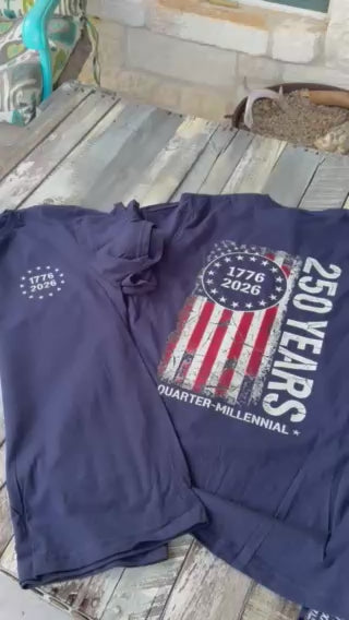 a soft navy unisex Gildan t-shirt with a crew neckline, short sleeves, a front 1776 / 2026 star circle graphic, a bold American flag and 250 YEARS Quarter-Millenial back design, and an easy year-round fit