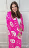 animated video of model snuggling with ultra-soft reversible throw on a pink and white happy face pattern print fabric in pink