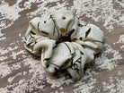 an oversized floral scrunchie with lightweight textured fabric, gathered construction, gentle hair-friendly hold, and easy pull-on styling in banana